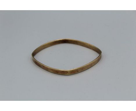 A 9ct gold square shaped bangle. Approximate weight 11.4 grams. With convention hallmark.