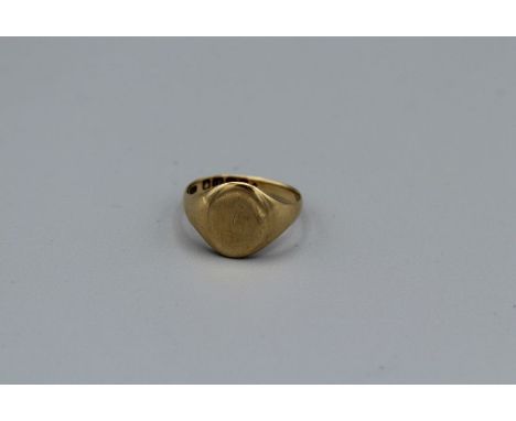 An 18ct gold signet ring, with faint remnants of initials. Hallmarked Birmingham 1916. Size R. Approximate weight 5.9 grams.