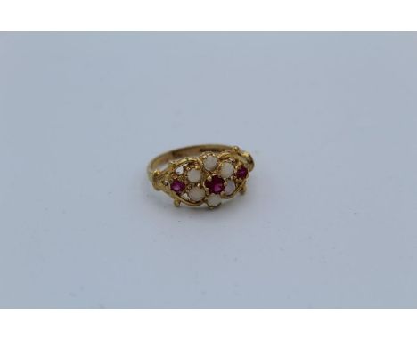 A 9ct yellow gold opal and ruby decorative cluster ring, size N.&nbsp;Gross weight approximately 2.5gm