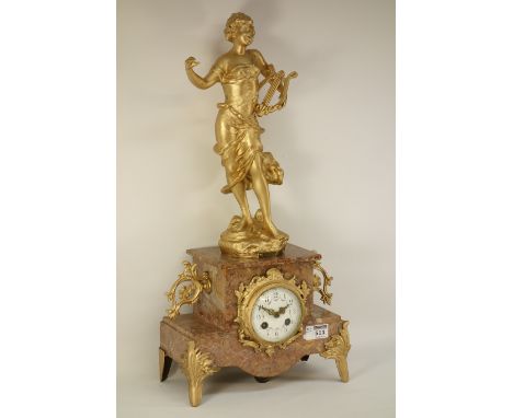 French gilt metal and marble figural clock, surmounted by spelter figure of a girl with lyre harp (signed), centre ceramic di