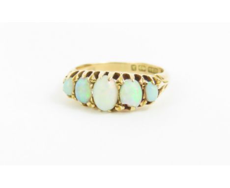 An 18ct gold opal five stone ring, the five oval cabochon cut opals graduated, finger size M, 3.5g gross