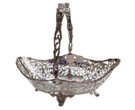 A silver swing-handled basket, by Josiah Williams & Co, London, 1918, oval form with pierced scrollwork sides and cast foliat
