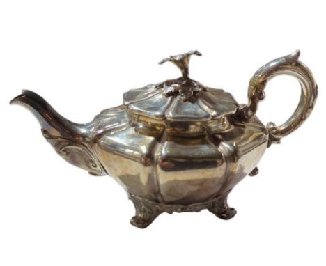 A William IV silver teapot, by John Tapley, London, 1935, lobeb circular form, leaf-capped scroll handle, the hinged cover wi