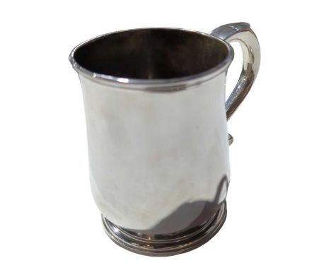 A George II silver mug, by Richard Burcombe, London, 1734, circular baluster form with scroll handle and raised on a spreadin