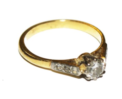 A single stone diamond ring with diamond shoulders