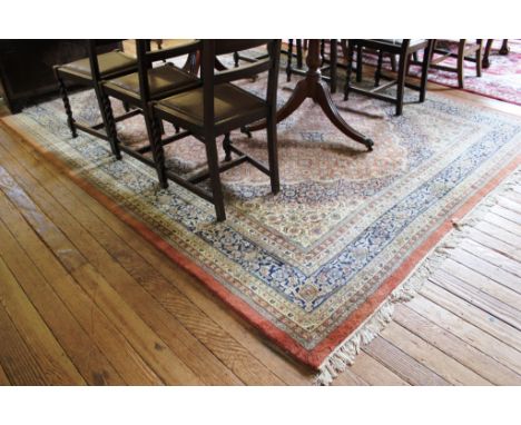 A Indian pink ground hand knotted wool pile drawing room carpet or rug with treble border, multicoloured floral and foliate d