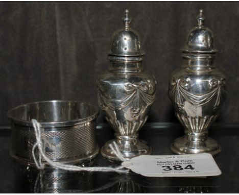 A pair of silver pepperettes and a silver napkin ring, Birmingham mixed dates 52 g