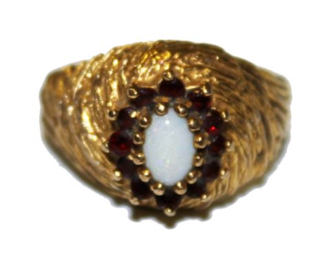A 9 carat gold garnet and opal ring