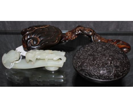 An Oriental jade belt buckle, a profusely carved sceptre and an elaborately carved circular wooden box with lid 