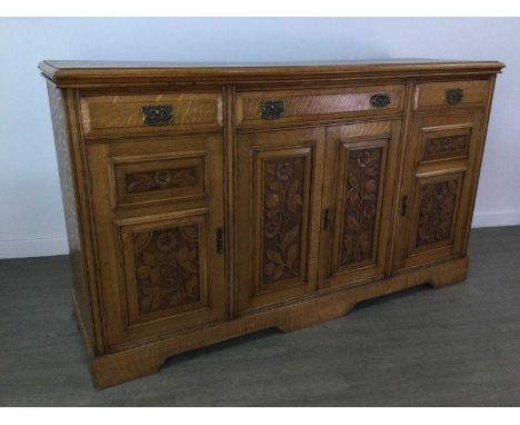 ARTS &amp; CRAFTS OAK SIDEBOARD,with three drawers above cupboard doors carved with floral panels, 170cm wideSplits and chips