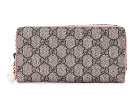 A GUCCI ZIP AROUND WALLET
Signature monogram canvas, gold-tone hardware with faux pearl zip-pull, pink leather interior with 