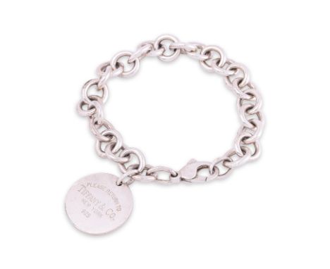 A TIFFANY & CO. SILVER ROUND TAG CHARM BRACELET
Lobster clasp closure, Marked '925'
Condition: For a condition report or furt