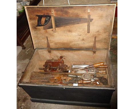 Large old carpenter's tool chest and contents comprising many wooden moulding planes, chisels, saws and drill bits, etc