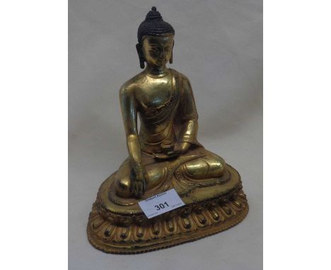 A Sino-Tibetan gilt bronze buddha seated holding a vase on a lotus base signed with foliate stamp to base 22cm high