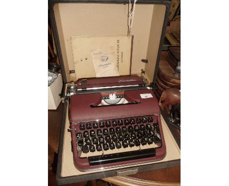 Olympia typewriter Model SM2, maroon colour with case and instructions