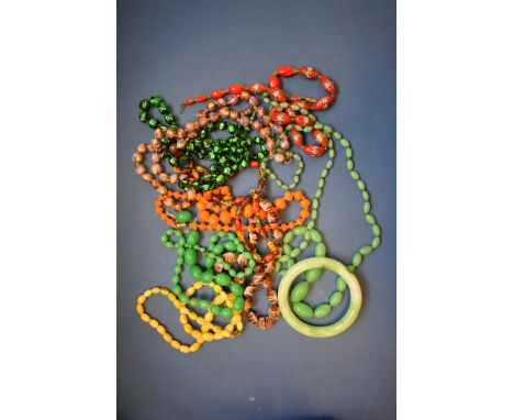 A jade bangle; together with two jade bead necklaces; and other glass beaded necklaces. 