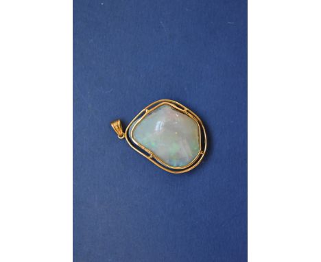 A polished uncut opal pendant, set in 18k gold wire mount, 3cm, 7g total weight. 