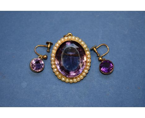 A large amethyst and pearl oval pendant, having brooch fitting; together with a pair of amethyst screw back earrings. 