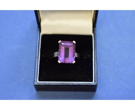 A 14k gold ring set square cut amethyst. 