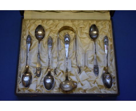 A cased set of Danish silver teaspoons, sugar tongs and cream ladle, having hammered bowls, one spoon missing, probably by Co