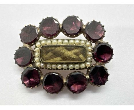 A Georgian Mourning Brooch, the central glazed hairwork panel within seed pearl border (rose colour closed back setting), 2.8