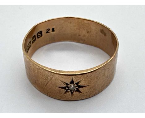A 9ct Gold Single Stone Diamond Ring, the brilliant cut diamond set within starburst style surround, between wide plain band 