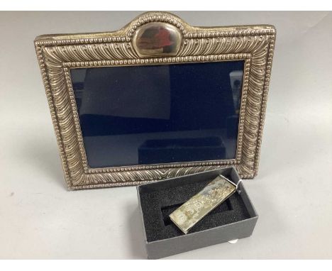 Carrs; A Hallmarked Silver Photograph Frame, Sheffield 1991, of shaped rectangular form with allover gadrooned design and bea
