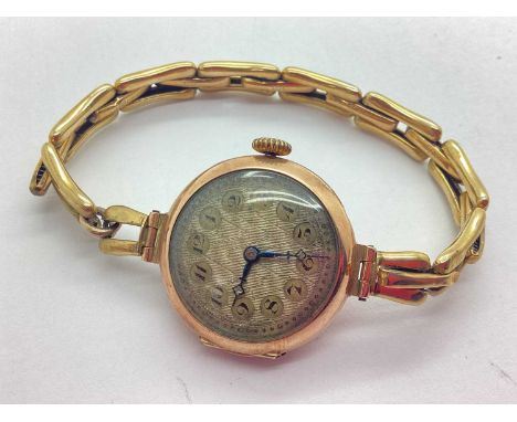 A 9ct Gold Cased Art Deco Style Wristwatch, the unsigned textured dial with black Arabic numerals, in a plain circular case, 