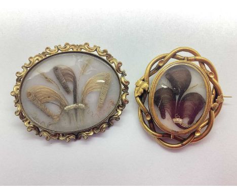An Antique Oval Hairwork Panel Brooch, within shaped frame, 6.3cm wide; together with a smaller XIX Century brooch, swivel lo