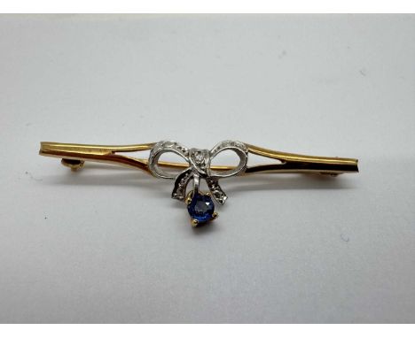A 9ct Gold Diamond and Stone Set Two-Tone Bar Brooch, the single stone diamond collet set within bow shaped setting, between 