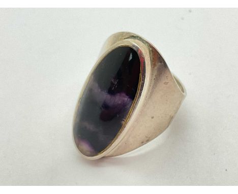 David Scott Walker; A Hallmarked Silver Blue John Panel Ring, the elongated oval stone rubover set between wide tapered shoul
