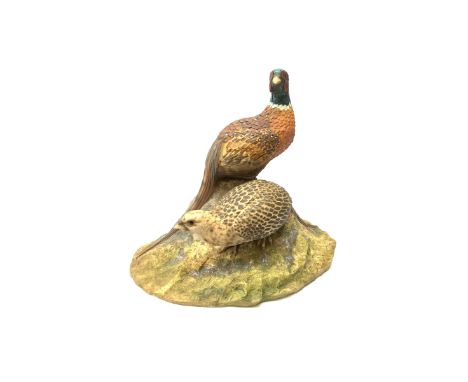 A North Light figure modelled as a cock and hen pheasant upon rocky ground, signed J Stanbridge 82, H26cm L30cmClick here to 
