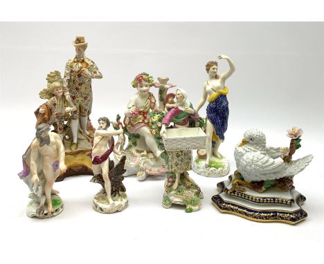 A group of assorted figures, to include a 19th century pottery figural group modelled as a flower seller with child upon her 