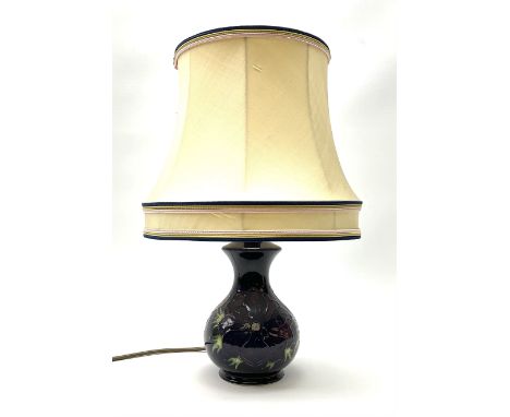 A Moorcroft table lamp, of baluster form, decorated in the Anemone pattern upon a dark blue ground, with impressed marks bene