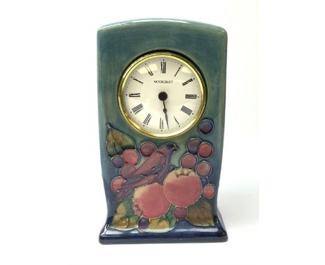 A Moorcroft mantel clock decorated in the Finches pattern upon a merging light and dark blue ground, with impressed and paint