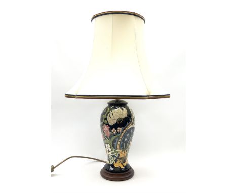A Moorcroft table lamp, of baluster form, decorated in the Golden Lily pattern upon a dark blue ground, with accompanying cre