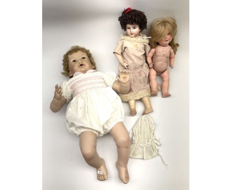 A modern ceramic head doll, with 'TA7703' and impressed signature to back of head, together with two other dolls. Click here 