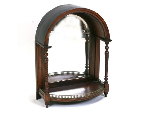 A Victorian rosewood dome topped mirrored back bracket with turned columns and brass gallery, 51cms (20ins) wide.