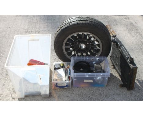 A quantity of TVR and Lotus Elan spares to include an 'M' series TVR alloy wheel, radiator, lights, service items, front &amp
