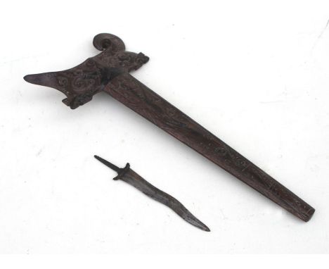 A carved wooden Kris scabbard 35cms (13.75ins) long together with an unassociated Kris blade that has an overall length inclu