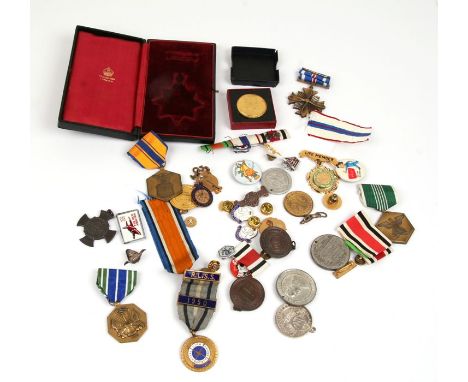 A quantity of enamel badges, medals and medallions.