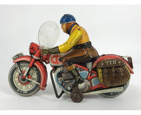A Tipp &amp; Co (Tippco) post WWII tin plate clockwork motorcycle and rider, manufactured in West Germany in the 1950s, model