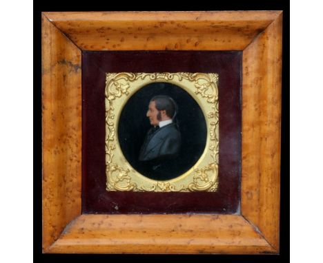 A Victorian waxwork silhouette of a gentleman wearing a black cloak and white shirt, in a maple frame, 19 by 20cms (7.5 by 8i