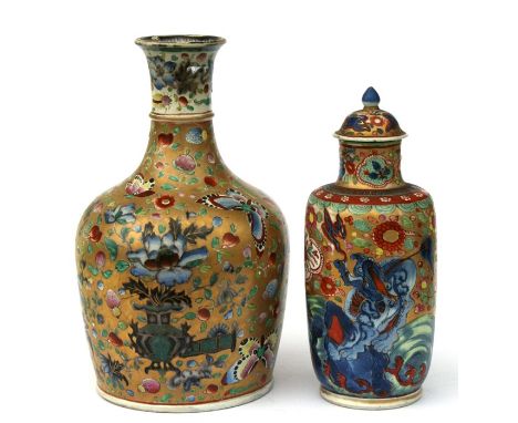 A Chinese clobbered vase and cover decorated with shi shi, phoenix and flowers on a gilded ground, red eight character mark t