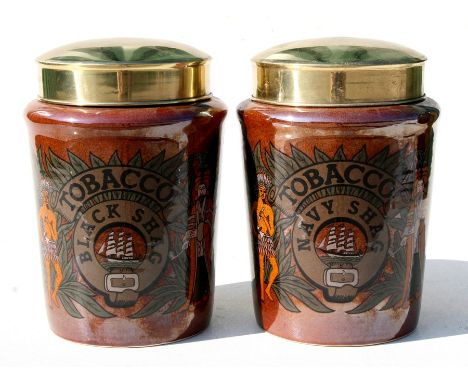A pair of ceramic tobacco jars with printed decoration - Navy Shag- and - Black Shag - with brass metal lids, each 24cms (9.5