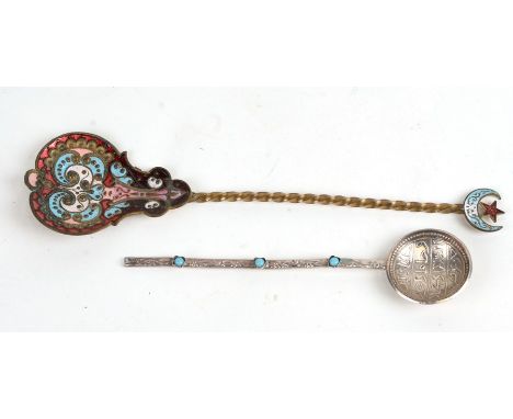 An Islamic white metal spoon with turquoise cabochons; together with a similar spoon with enamel decoration (2).