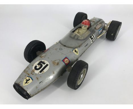 A RICO Ferrari F1 GP tin plate friction drive car, with racing legend Fangio at the wheel, featuring lithograph printed graph