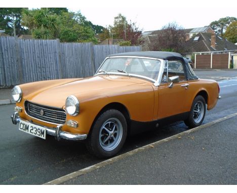 A 1974 MG Midget 1275, Registration number CDM 239M, chassis number GAN5-04567GE, engine number 1389, orange. This low owners