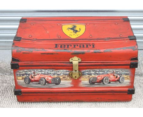A vintage tin trunk, later decorated with a Ferrari Prancing Horse emblem and two Monoposto Ferrari racing cars, 70cms (27.5i