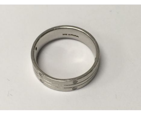 A platinum ring inset with diamonds 9 grams size o